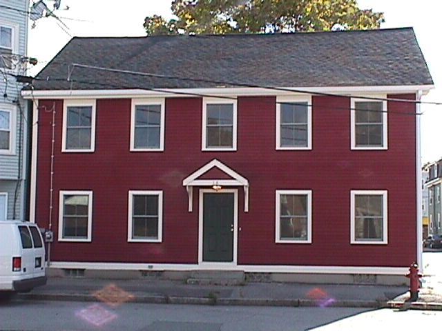 The exterior of a red home after a home rehab